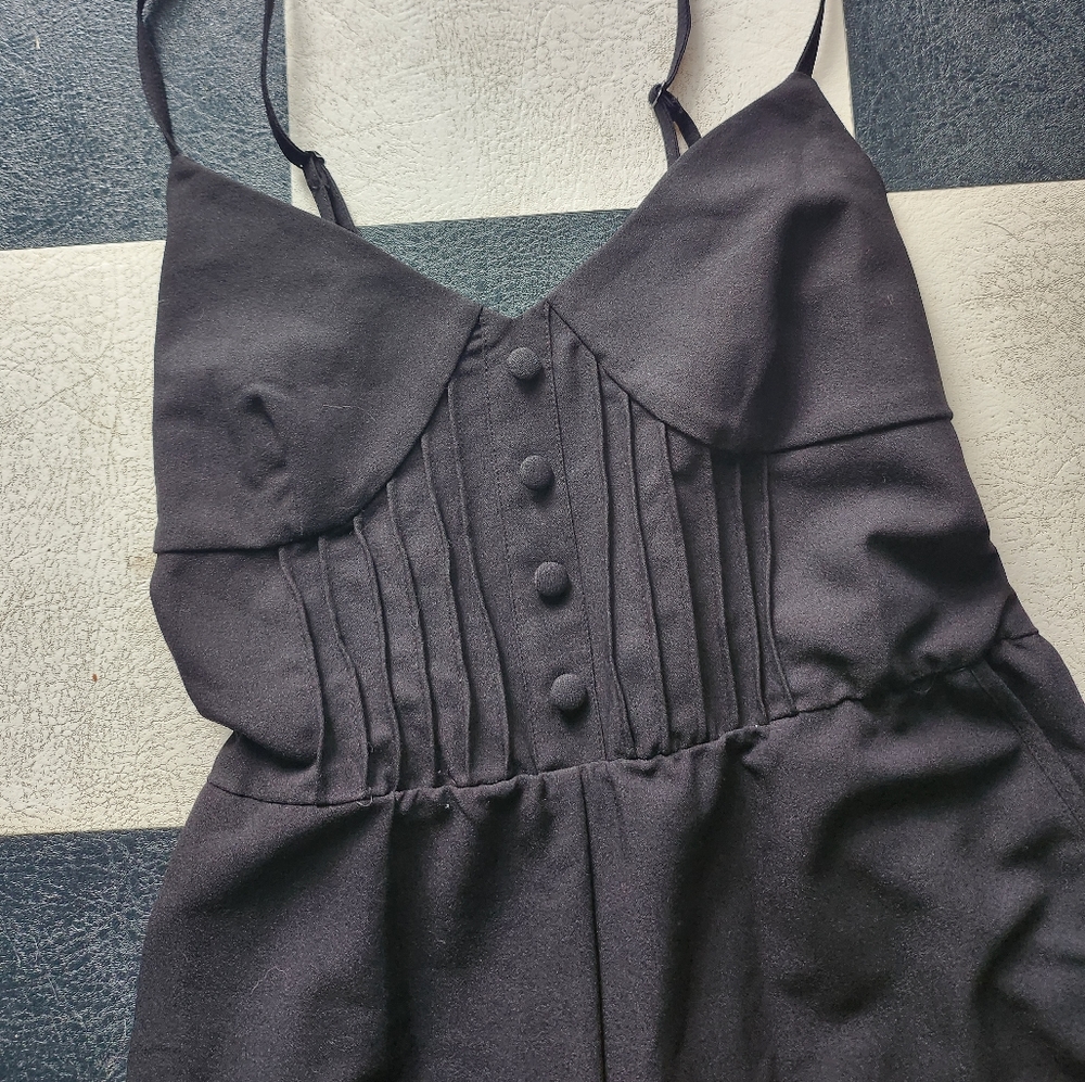 Black Kim Kardashian jumpsuit/rompers with pockets from Fall 2012 collection.